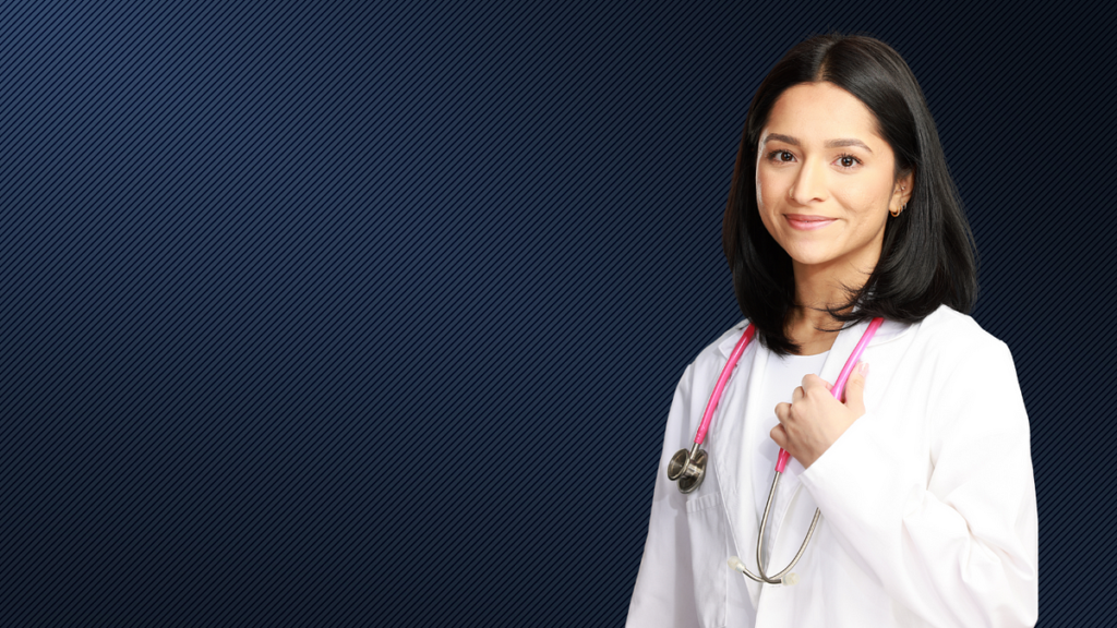 Neonatal care nurse Ami Bulsara stands in front of a blue backdrop.