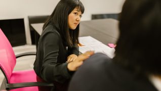 Focused woman engaging in a professional meeting in an office setting.